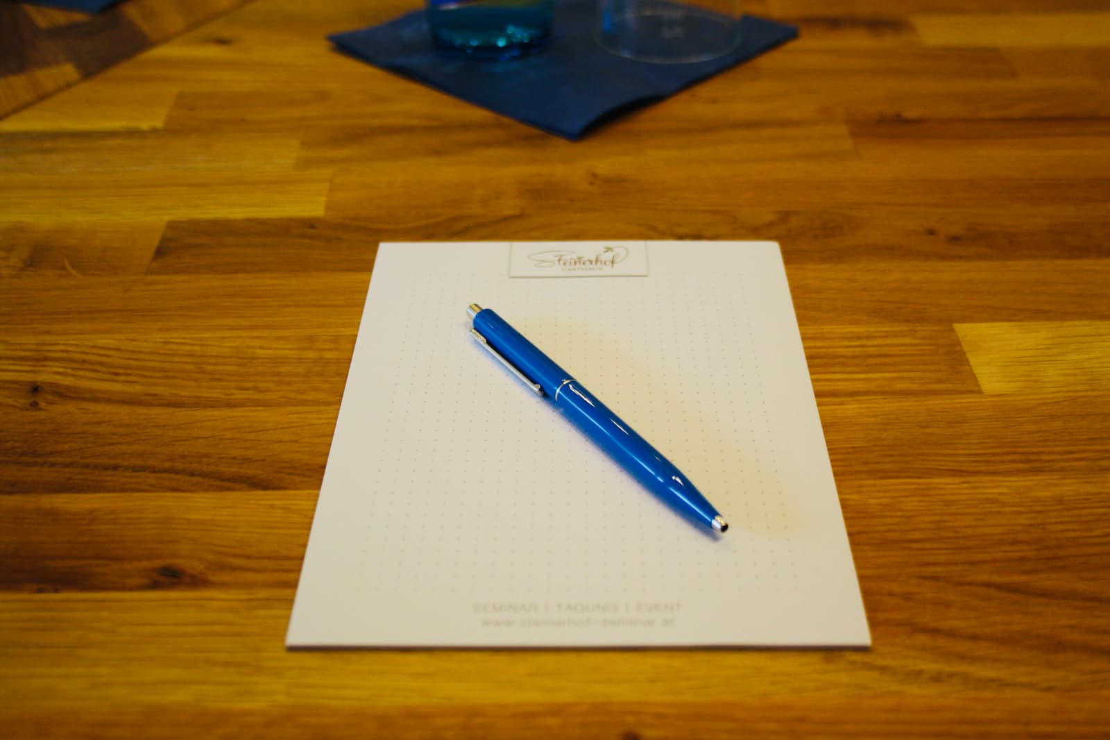 Notizblock und Stift auf dem Seminartisch